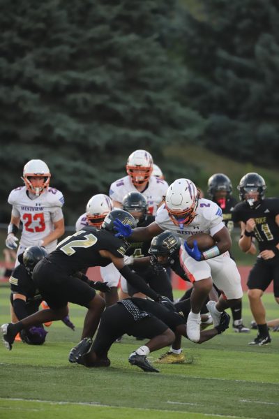 Running back Sage Giddings Jukes out a Burke defender at the game on September 13th. Sage helped his team to a 42-7 win in their third game of the season. Photo by Danika Leon Wilson 