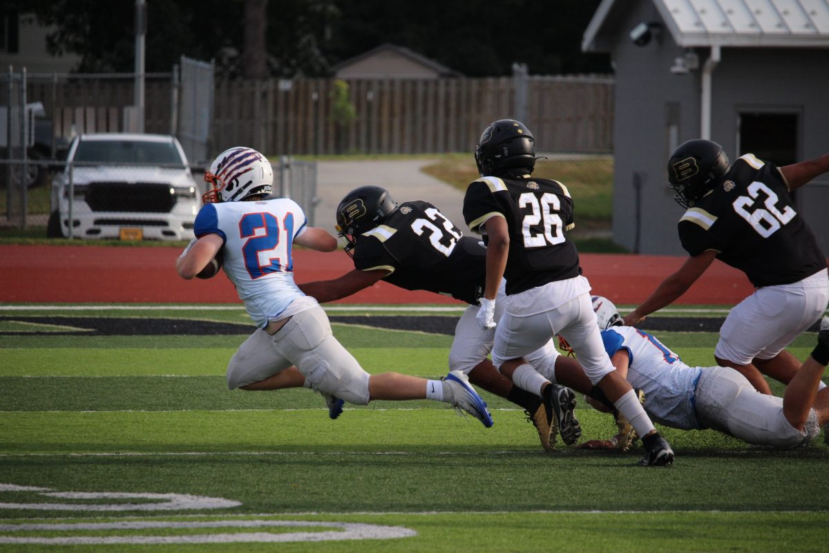 Jack Peterson lunges out after the defender tripped him. Peterson returned the short punt by Burke 20 yards before he was finally taken down. 
