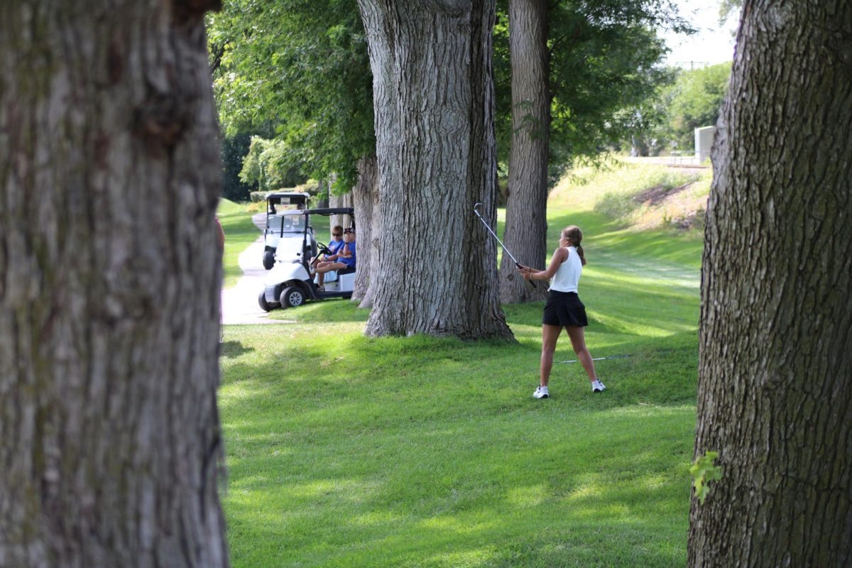 Faith Koranda, 12, takes her chip shot at the green on the second hole at Fremont Golf Course. After her shot, Koranda made the putt, securing a strong start to her eventual first place round. Photo taken by Logan Jokumsen. 