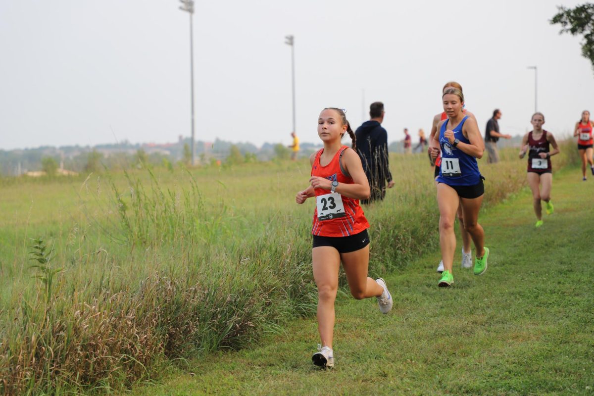 Lucy Fiero, 12, runs down a long straight stretch during her race keeping away from the people behind her. Fiero continued her streak of good runs with another medal by the finish.  