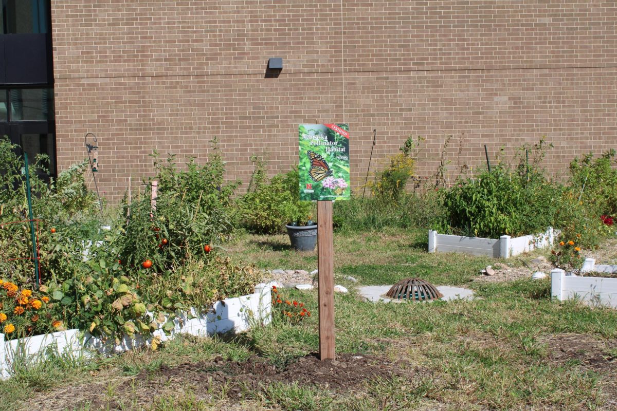 Westview's pollinator garden sits in the sun with new certification posted on a sign. The garden had to pass many requirements to gain the certificate.